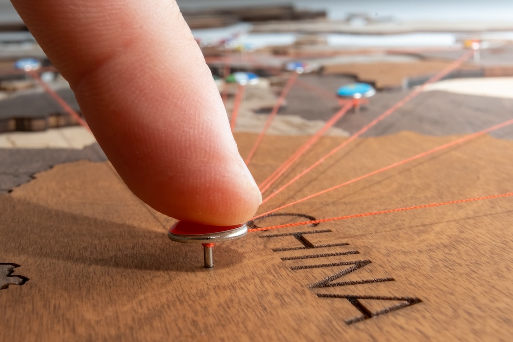 close-up-man-pushes-pin-with-israel-flag-into-wood-2023-11-27-04-51-08-utc.jpg